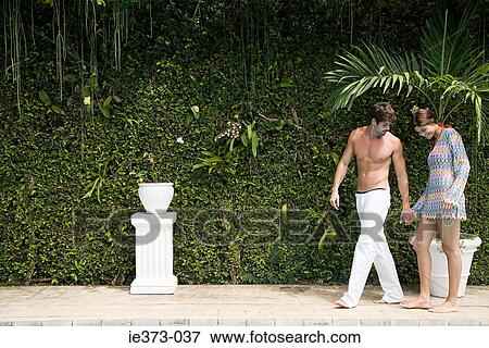 Stock Photo - Hispanic couple walking hand in hand. Fotosearch