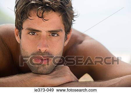 Stock Photo - Hispanic man sunbathing. Fotosearch
