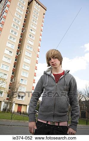 Boy by tower block View Large Photo Image Stock Image - Boy by tower block. Fotosearch