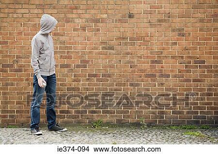 Picture - Boy by wall with spray can. Fotosearch