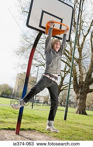 Boy holding basketball hoop View Large Photo Image Stock Image - Boy holding basketball hoop. Fotosearch