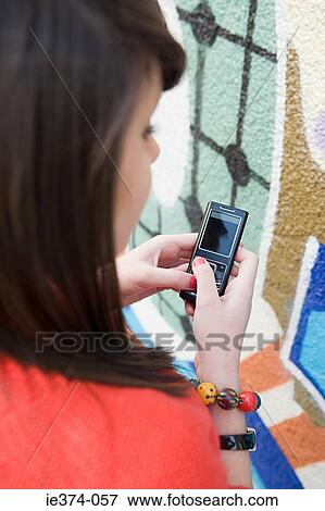 Girl using cellphone View Large Photo Image Stock Photo - Girl using cellphone. Fotosearch