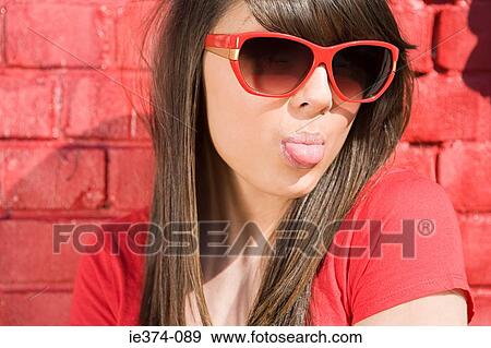 Stock Photo - Girl wearing sunglasses. Fotosearch