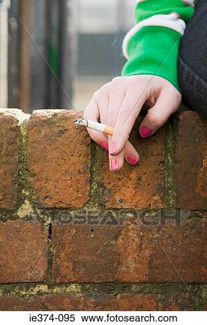 Hand of a girl with cigarette View Large Photo Image Stock Photography - Hand of a girl with cigarette. Fotosearch