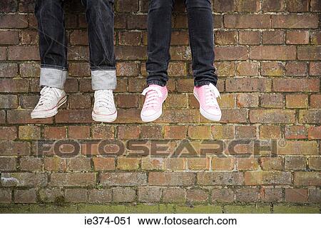 Legs of teenagers on wall View Large Photo Image Stock Image - Legs of teenagers on wall. Fotosearch