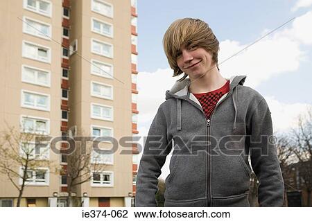Teenage boy by tower block View Large Photo Image Stock Image - Teenage boy by tower block. Fotosearch
