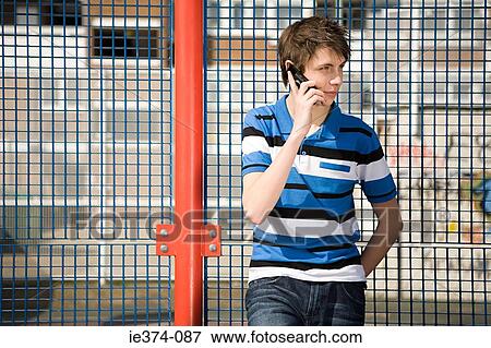 Stock Photo - Teenage boy on cellphone. Fotosearch
