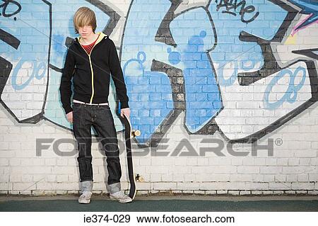 Teenage boy with skateboard View Large Photo Image Stock Photo - Teenage boy with skateboard. Fotosearch