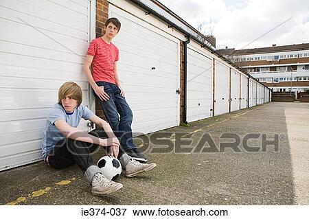 Teenage boys by garages View Large Photo Image Stock Photo - Teenage boys by garages. Fotosearch