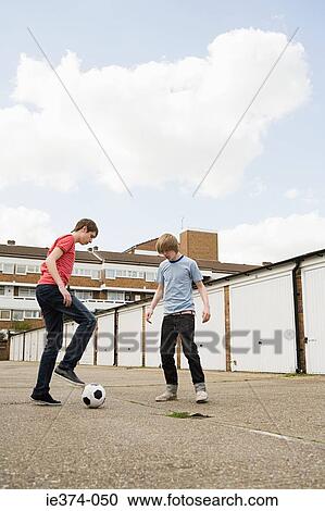 Teenage boys playing football View Large Photo Image Stock Image - Teenage boys playing football. Fotosearch