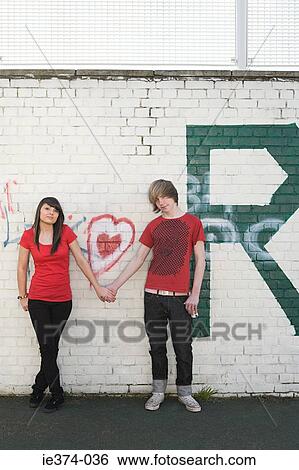 Stock Photograph - Teenage couple holding hands. Fotosearch
