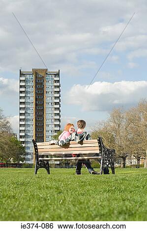 Teenage couple on bench View Large Photo Image Stock Photograph - Teenage couple on bench. Fotosearch