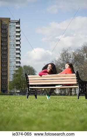 Stock Photography - Teenage girls on bench. Fotosearch
