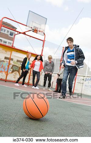 Teenagers in basketball court View Large Photo Image Stock Image - Teenagers in basketball court. Fotosearch