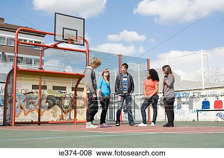 Stock Photo - Teens on basketball court. Fotosearch