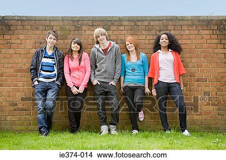 Teens standing by wall View Large Photo Image Picture - Teens standing by wall. Fotosearch