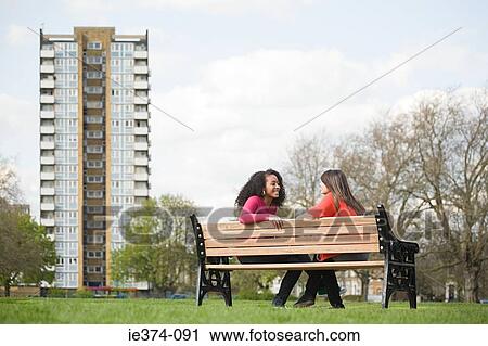 Two teenage girls on a bench View Large Photo Image Stock Image - Two teenage girls on a bench. Fotosearch