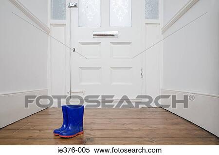 Stock Photography - Childrens boots by door. Fotosearch