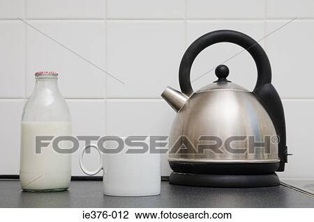 Stock Image - Kettle with cup and milk. Fotosearch