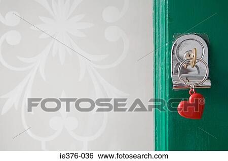 Key in front door View Large Photo Image Stock Photograph - Key in front door. Fotosearch