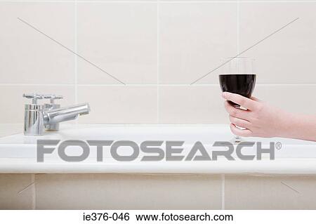 Person in the bath with wine View Large Photo Image Stock Photograph - Person in the bath with wine. Fotosearch