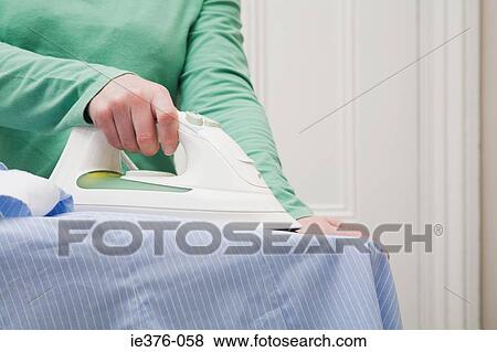 Woman ironing View Large Photo Image Stock Photo - Woman ironing. Fotosearch