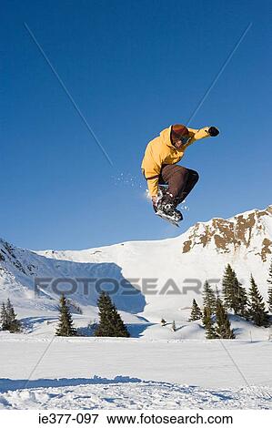 Stock Photo - A man snowboarding. Fotosearch