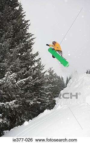 Stock Photograph - A man snowboarding. Fotosearch