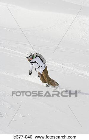 A woman snowboarding View Large Photo Image Stock Image - A woman snowboarding. Fotosearch