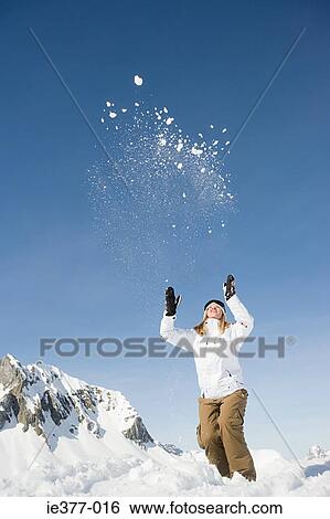 A woman throwing snow View Large Photo Image Stock Photograph - A woman throwing snow. Fotosearch