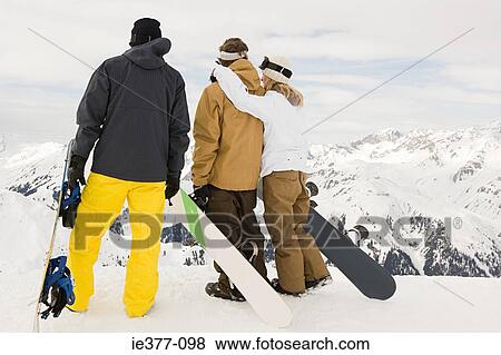 Rear view of snowboarders View Large Photo Image Stock Photo - Rear view of snowboarders. Fotosearch