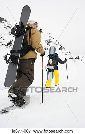 Rear view of two men skiing View Large Photo Image Stock Photo - Rear view of two men skiing. Fotosearch