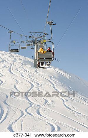 Two people on a ski lift View Large Photo Image Stock Image - Two people on a ski lift. Fotosearch