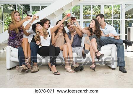 Friends drinking on a sofa View Large Photo Image Stock Image - Friends drinking on a sofa. Fotosearch