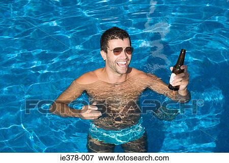 Man drinking beer in swimming pool View Large Photo Image Stock Photo - Man drinking beer in swimming pool. Fotosearch
