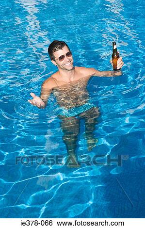 Man drinking beer in swimming pool View Large Photo Image Stock Photograph - Man drinking beer in swimming pool. Fotosearch