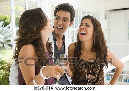 Man laughing with women View Large Photo Image Picture - Man laughing with women. Fotosearch