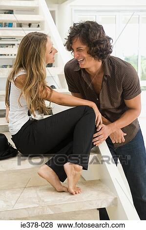 Young couple laughing at home View Large Photo Image Stock Photo - Young couple laughing at home. Fotosearch
