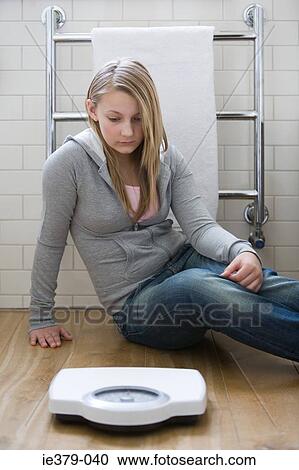 A girl looking at scales View Large Photo Image Stock Image - A girl looking at scales. Fotosearch