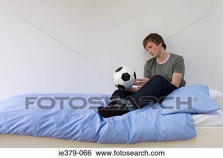 A teenage boy holding a football View Large Photo Image Stock Photograph - A teenage boy holding a football. Fotosearch