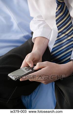A teenage boy using a cell phone View Large Photo Image Stock Image - A teenage boy using a cell phone. Fotosearch