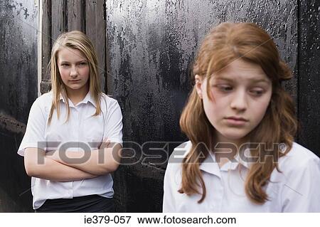 Stock Photo - A teenage girl being bullied. Fotosearch