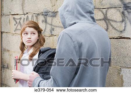 Picture - A teenage girl getting mugged. Fotosearch