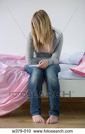 A teenage girl holding a pregnancy test View Large Photo Image Stock Image - A teenage girl holding a pregnancy test. Fotosearch