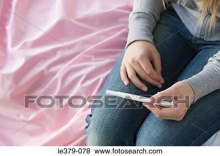 A teenage girl holding a pregnancy test View Large Photo Image Stock Photo - A teenage girl holding a pregnancy test. Fotosearch