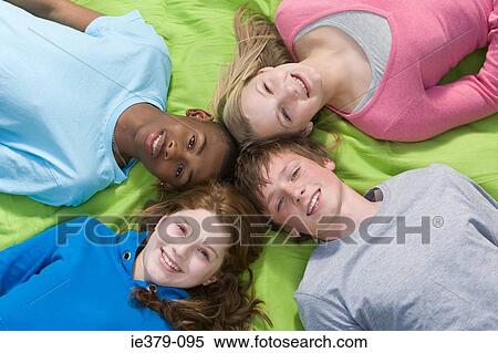 Elevated view of teenagers lying down View Large Photo Image Stock Photography - Elevated view of teenagers lying down. Fotosearch