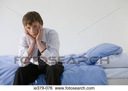 Portrait of a teenage boy sat on a bed View Large Photo Image Stock Photograph - Portrait of a teenage boy sat on a bed. Fotosearch