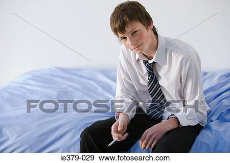 Portrait of a teenage boy smoking View Large Photo Image Stock Photo - Portrait of a teenage boy smoking. Fotosearch