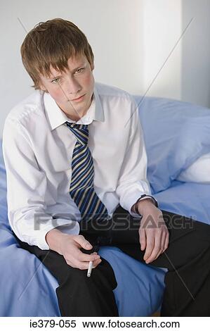 Stock Photography - Portrait of a teenage boy smoking. Fotosearch