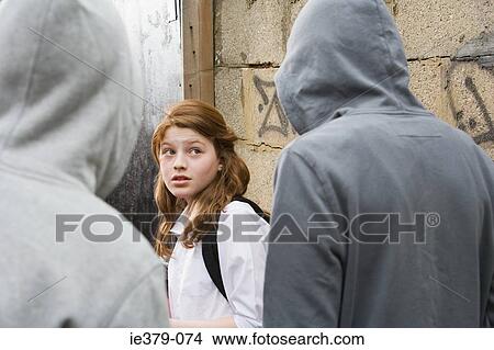 Teenage boys intimidating a teenage girl View Large Photo Image Picture - Teenage boys intimidating a teenage girl. Fotosearch